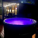 A Tiny House With A Garden And A Hot Tube