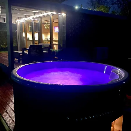 A Tiny House With A Garden And A Hot Tube